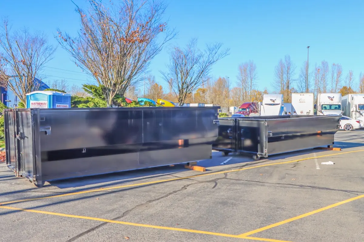 Professional dumpster rental service with roll-off container on residential driveway in Boulder Creek